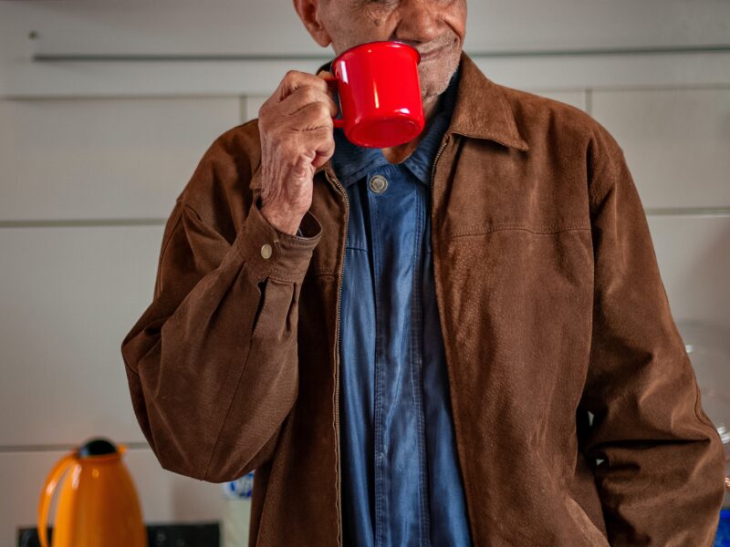 Older man holding a red cup