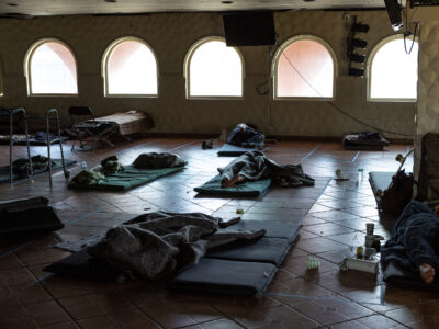 People on cots in a shelter