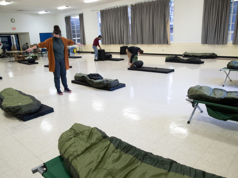 Group setting up sleeping area in shelter