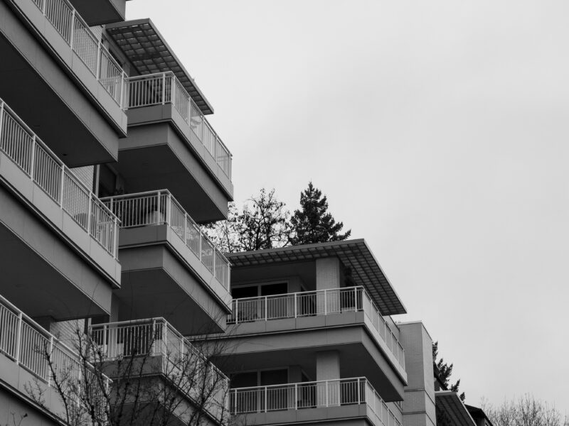 Image Description: Apartments in the West Hills on a cloudy day. Photo by Sean Benesh on Unsplash