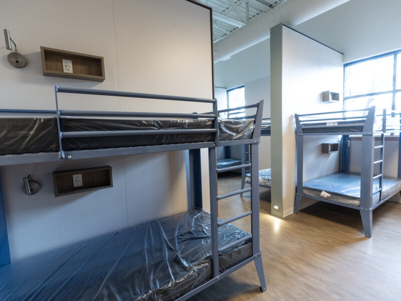 Bunk beds in a room separated by a wall